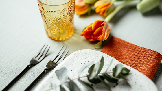 A place setting in orange and green
